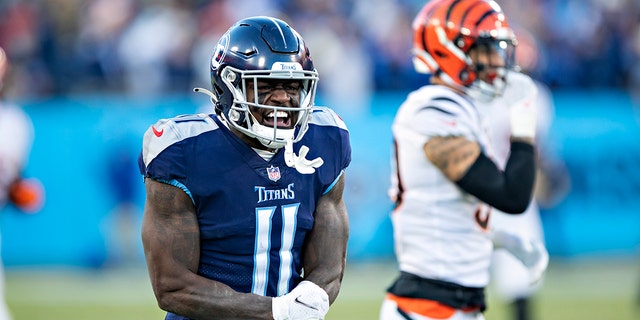  A.J. Brown #11 of the Tennessee Titans celebrates after a big catch during a game against the Cincinnati Bengals in the AFC Divisional Playoff game at Nissan Stadium on January 22, 2022 in Nashville, Tennessee. The Bengals defeated the Titans 19-16.  