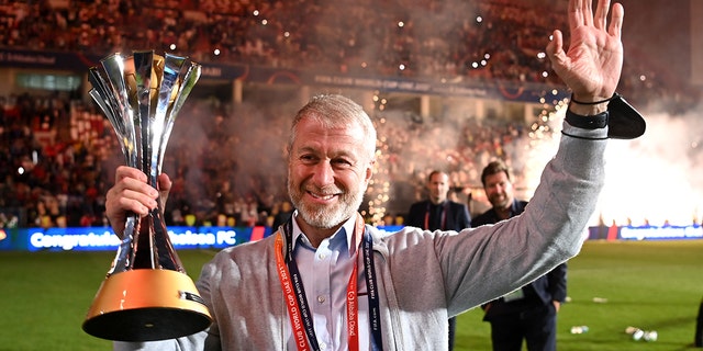 Roman Abramovich, owner of Chelsea, celebrates with the FIFA Club World Cup trophy after a victory during the FIFA Club World Cup UAE 2021 final match between Chelsea and Palmeiras at Mohammed Bin Zayed Stadium Feb. 12, 2022, in Abu Dhabi, United Arab Emirates. 