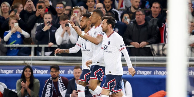 Kylian Mbappe of Paris Saint-Germain (center) celebrates a goal with Neymar Jr. and Lionel Messi during a Ligue 1 Uber Eats match between RC Strasbourg and PSG at Stade de la Meinau April 29, 2022, in Strasbourg, France. 