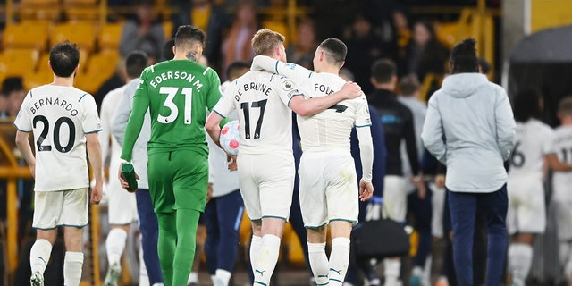 Kevin De Bruyne of Manchester City holds the match ball following a hat trick in a Premier League match at Molineux, May 11, 2022, in Wolverhampton, England. 