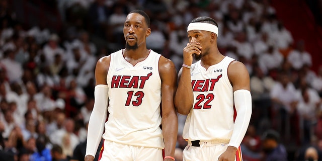 Bam Adebayo and Jimmy Butler of the Heat talk during the second quarter against the Boston Celtics on May 19, 2022 in Miami, Florida.