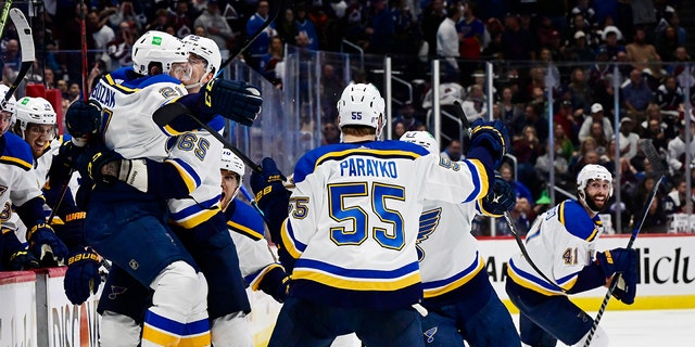 St. Louis Blues center Tyler Bozak, left, celebrates his game-winning overtime goal against the Colorado Avalanche in Denver on May 25, 2022.