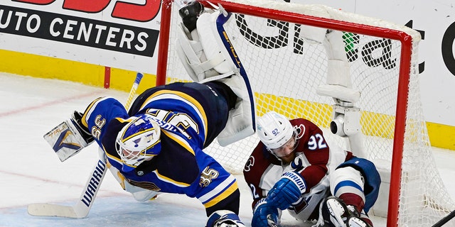 Colorado Avalanche left wing Gabriel Landeskog (92) slides into the net, upending St. Louis Blues goaltender Ville Husso (35) in the third period during Game 6 of the second round of the NHL Stanley Cup playoffs at the Enterprise Center May 27, 2022. 