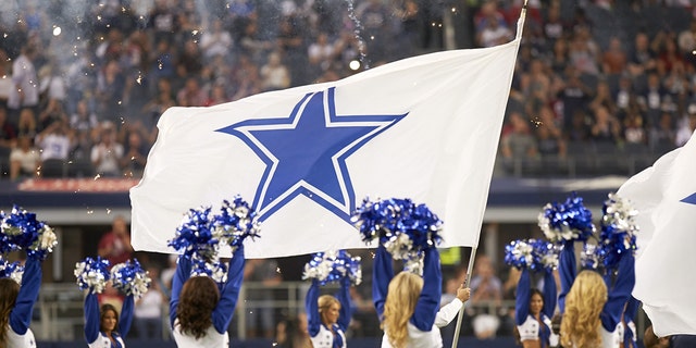 View of Dallas Cowboys cheerleaders on field during preseason game vs Houston Texans at AT&amp;T Stadium.
