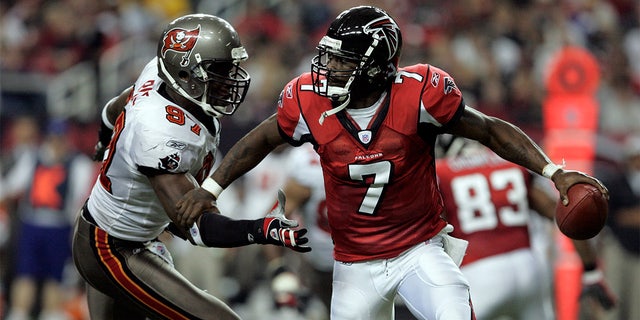 Michael Vick (7) of the Atlanta Falcons is rushed by Simeon Rice (97) of the Tampa Bay Buccaneers in the Tampa Bay Buccaneers 30-27 victory over the Atlanta Falcons at the Georgia Dome in Atlanta Georgia.