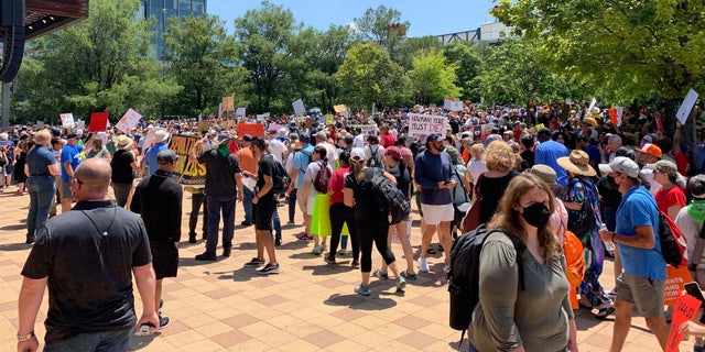 Protesters stand outside of the NRA Convention in Texas.