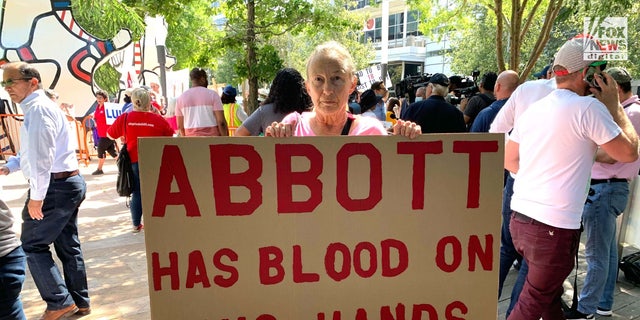 Linda Bennett, a Houston resident, protests outside of the 2022 NRA Convention in Texas.