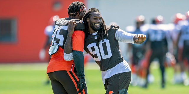 Cleveland Browns defensive linemen Jadeveon Clowney, right, goofs around with defensive linemen Myles Garrett (95) during an NFL football practice in Berea, Ohio, Wednesday, Aug. 4, 2021.