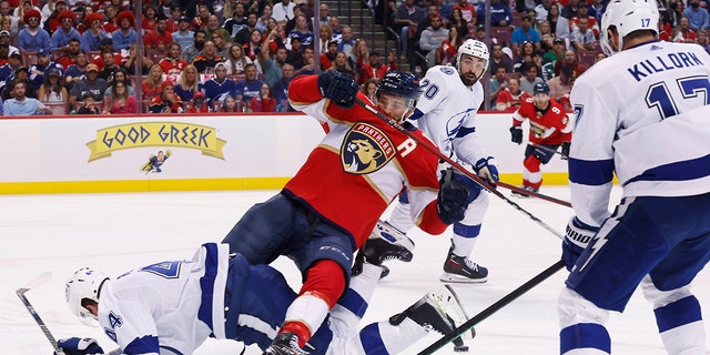 Tampa Bay Lightning defenseman Jan Rutta (44) takes down Florida Panthers left wing Jonathan Huberdeau as Lightning' Alex Killorn (17) and Nicholas Paul (20) watch during the second period of Game 2 of an NHL hockey second-round playoff series Thursday, May 19, 2022, in Sunrise, Fla.