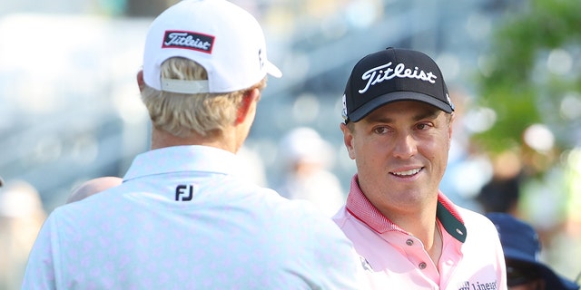 Justin Thomas of the United States and Will Zalatoris of the United States shake hands on the 13th tee, the first playoff hole, during the final round of the 2022 PGA Championship at Southern Hills Country Club on May 22, 2022 in Tulsa, Oklahoma.