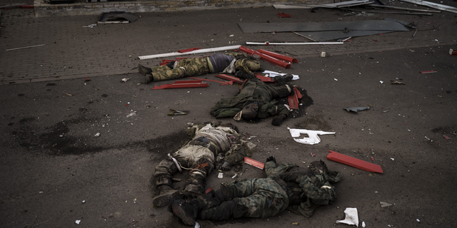 The bodies of unidentified men, believed to be Russian soldiers, arranged in a Z, a symbol of the Russian invasion, lie near a village recently retaken by Ukrainian forces on the outskirts of Kharkiv, Ukraine, on Monday, May 2.