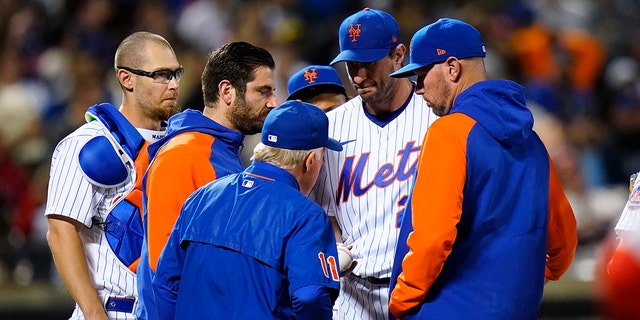 New York Mets starting pitcher Max Scherzer hands the ball to manager Buck Showalter during the sixth inning of the team's baseball game against the St. Louis Cardinals on Wednesday, May 18, 2022, in New York. 