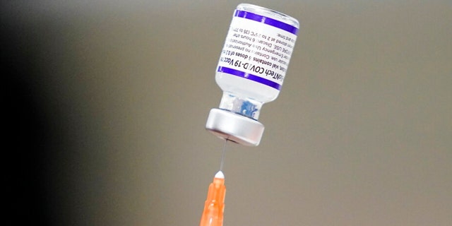 FILE - A syringe is prepared with the Pfizer COVID-19 vaccine at a vaccination clinic at the Keystone First Wellness Center in Chester, Pa., on Dec. 15, 2021. Pfizer is expected to request authorization for an additional COVID-19 booster dose for seniors. 