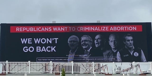 The Democratic Senatorial Campaign Committee (DSCC) goes up with a billboard ahead of GOP Sen. Rick Scott's trip to New Hampshire that takes aim at Republicans over the abortion issue, on May 20, 2022, in Manchester. 