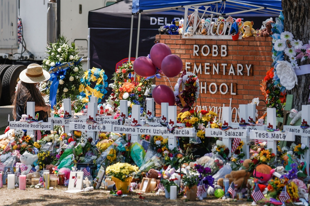 Crosses bearing the names of the shooting victims are planted at the entrance of Robb Elementary School in Uvalde, Texas on May 28, 2022.