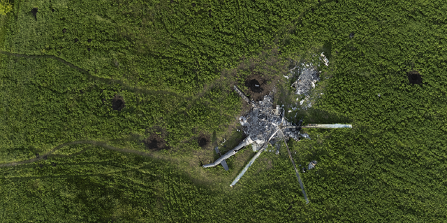 The remains of a destroyed Russian helicopter lie in a field in the village of Malaya Rohan, in the Kharkiv region of Ukraine, on May 16.