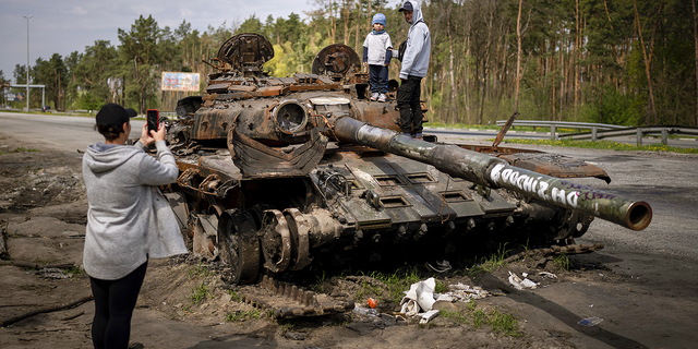 Maksym, 3, is photographed with his brother, Dmytro, 16, on top of a destroyed Russian tank, on the outskirts of Kyiv, Ukraine, on May 8.