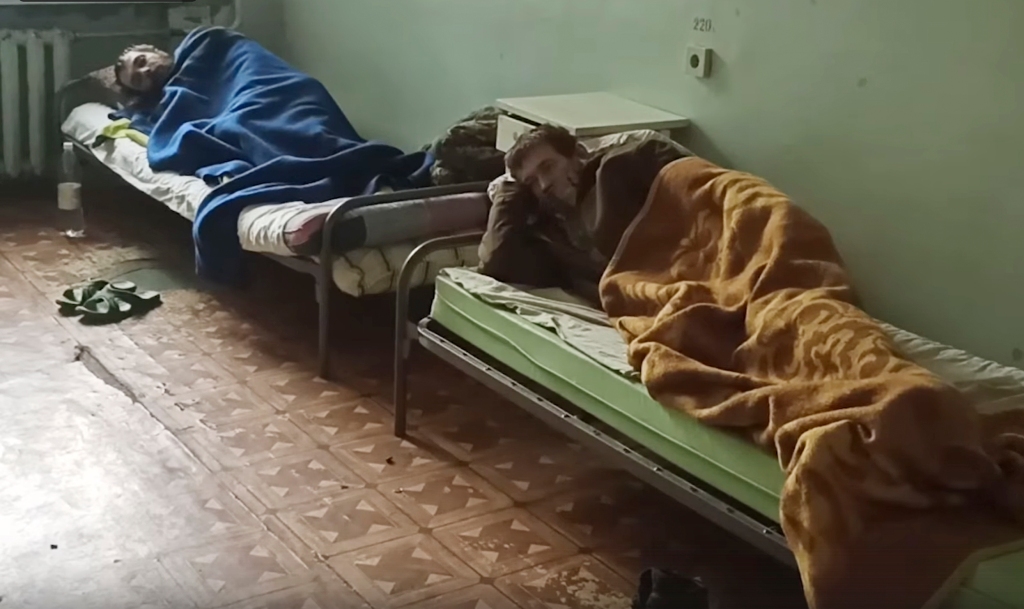 Wounded Ukrainian servicemen are seen laying on hospital beds in Novoazovsk, Ukraine, on on May 18, 2022.