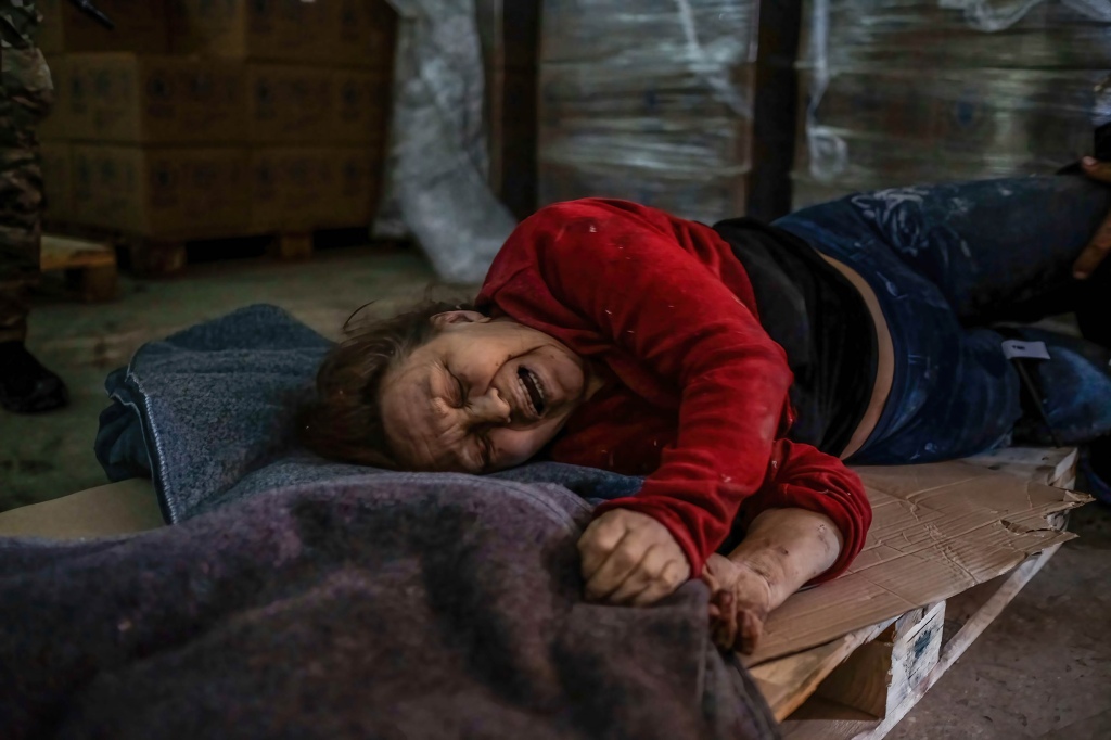 After being hit by Russian shelling, an injured woman cries in pain while receiving the first aid at the Humanitarian Aid Center in Severodonetsk.