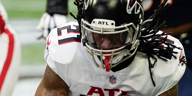 Atlanta Falcons running back Todd Gurley (21) runs through the hole against the Denver Broncos during the first half of an NFL football game, Sunday, Nov. 8, 2020, in Atlanta.