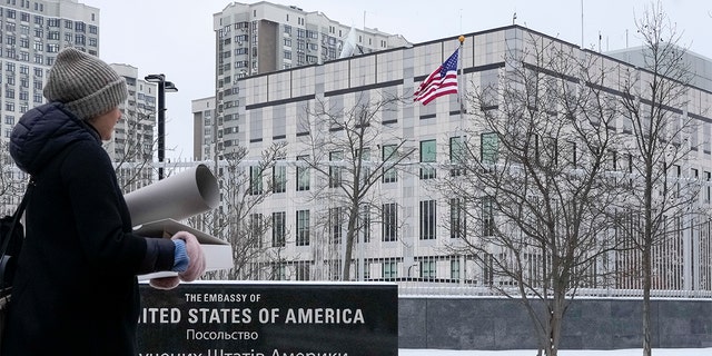 A woman walks past the U.S. Embassy in Kyiv, Ukraine, on Monday, Jan. 24.