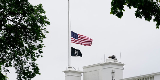 The American flag flies at half-staff at the White House in Washington, Thursday, May 12, 2022, as the Biden administration commemorates 1 million American lives lost due to COVID-19. 