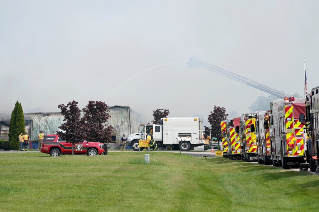 Emergency crews work to extinguish a fire at Summerset Marine Construction in Eagle, Wis., on Thursday, May 19, 2022.