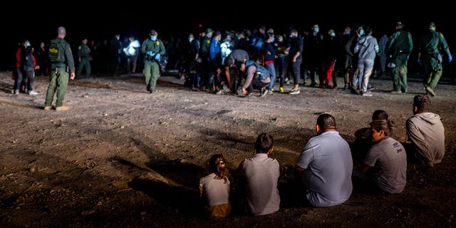 A migrant family sits after being processed in Roma, Texas. (Photo by Brandon Bell/Getty Images)