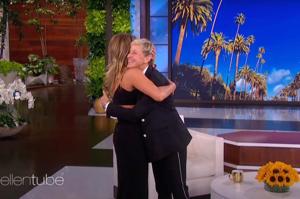 Aniston hugs host and longtime pal Ellen Degeneres.