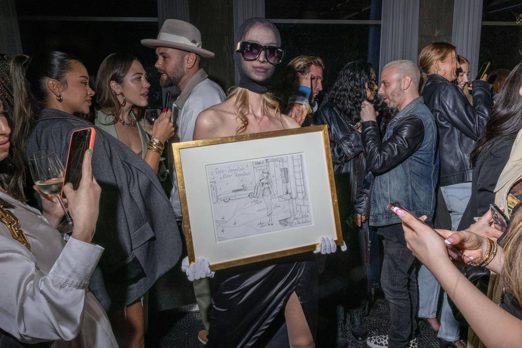 A model holding one of Sorokin's pieces of art at the show on May 19, 2022.