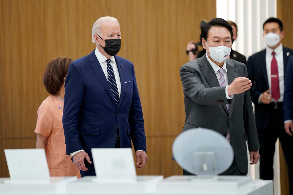 President Joe Biden is escorted by South Korean President Yoon Suk Yeol