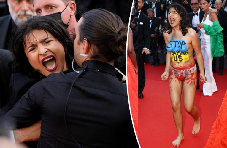 Topless, screaming woman crashes Cannes red carpet to protest war crimes