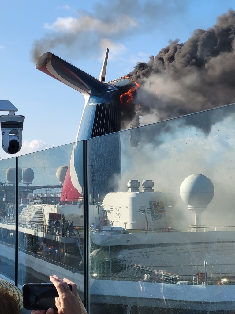 Photos and videos on Twitter show smoke and flames billowing from a cruise ship docked in Grand Turk on Thursday.
