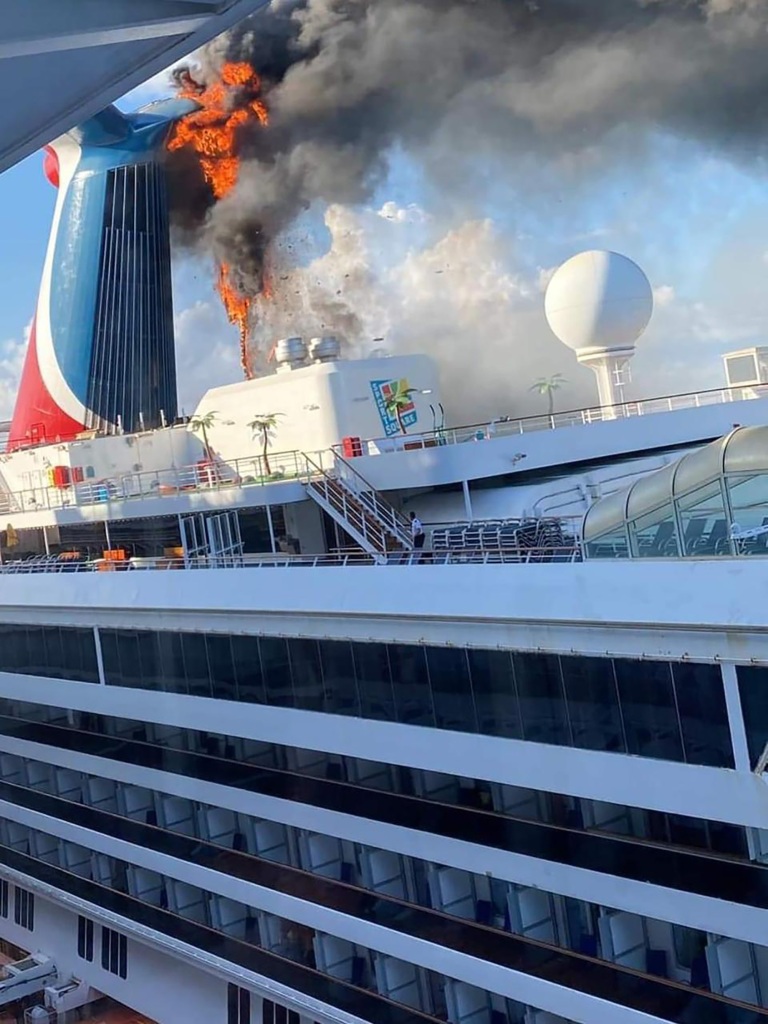 Photos and videos on Twitter show smoke and flames billowing from a cruise ship docked in Grand Turk on Thursday.
