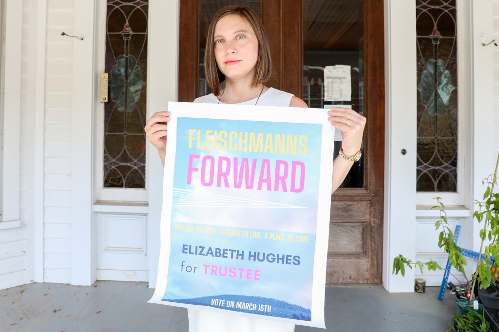 Elizabeth Hughes holds an campaign poster.