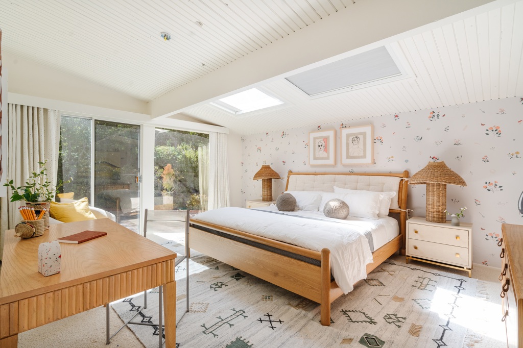 The midcentury manse fills with light, as is seen in this bedroom photo.