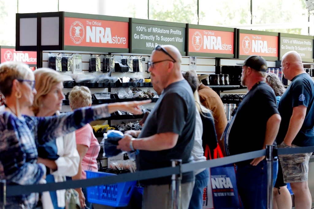 Convention attendees wait in line to buy NRA branded merchandise.