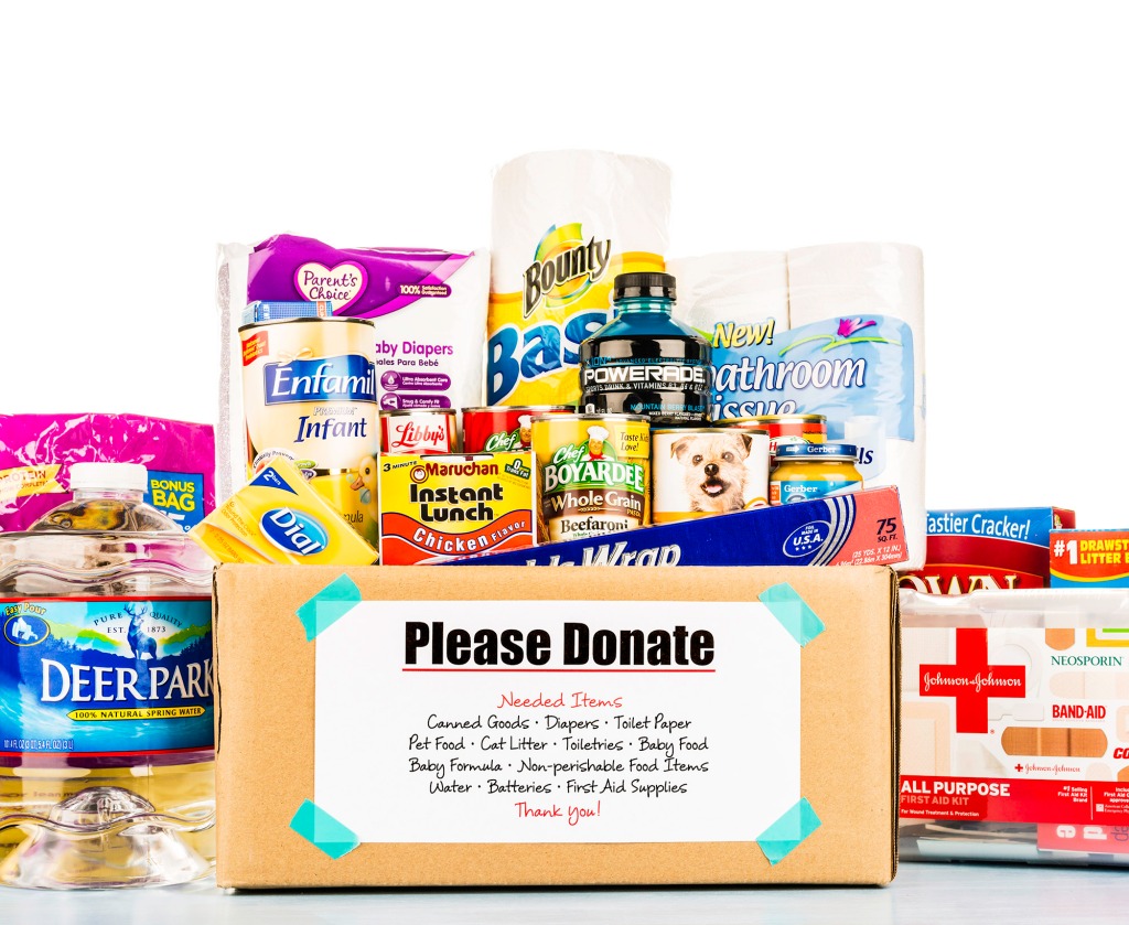 Various first aid, foods, in box labeled 'please donate.'