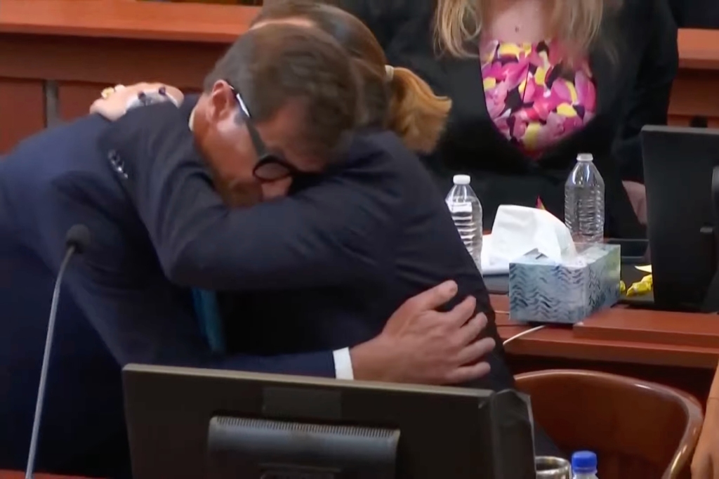 Attorney Benjamin Chew and Johnny Depp embrace.