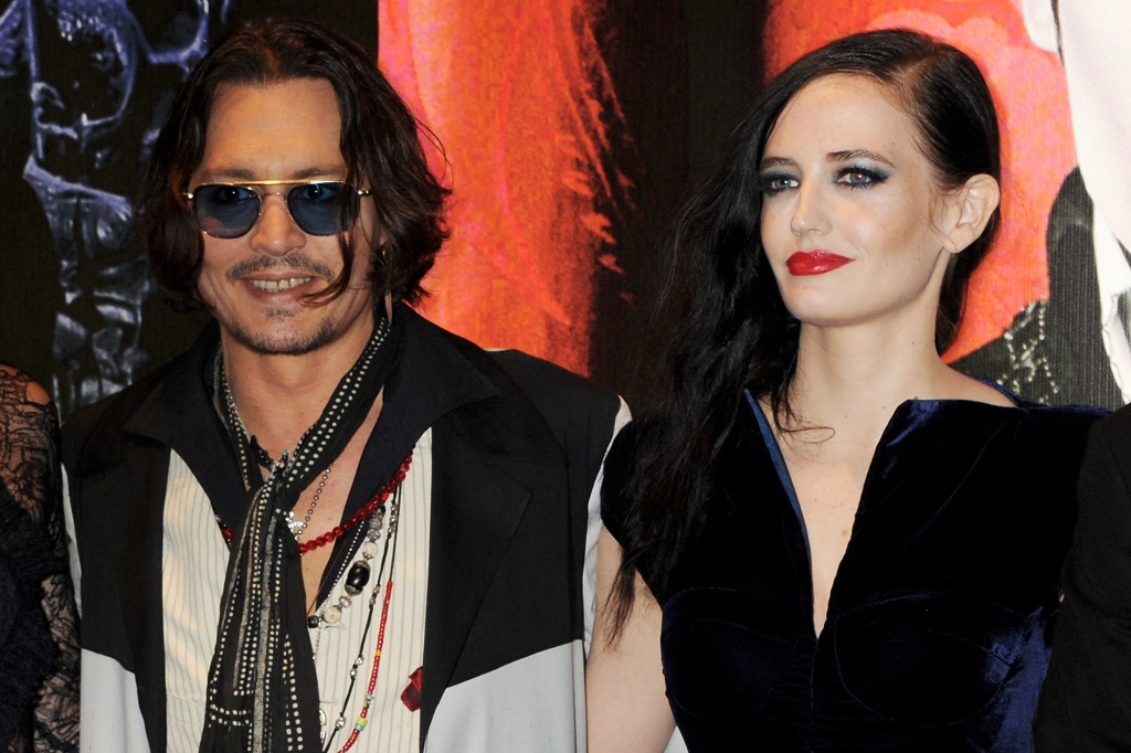 Actors Johnny Depp (L) and Eva Green attend the European Premiere of 'Dark Shadows' at Empire Leicester Square on May 9, 2012 in London, England.  