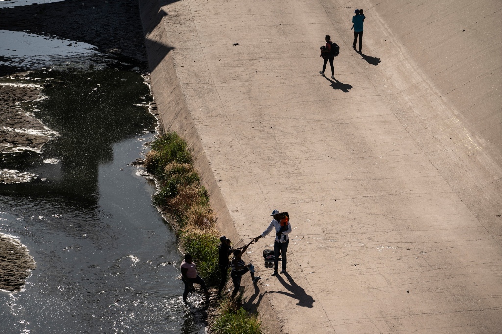 Migrants cross the Rio Bravo River to turn themselves into US Border Patrol agents as they request asylum on May 19. 