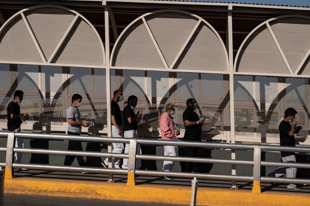 Asylum-seeking migrants walk on Paso Del Norte International Bridge to enter Mexico after being expelled from the US on May 19. 
