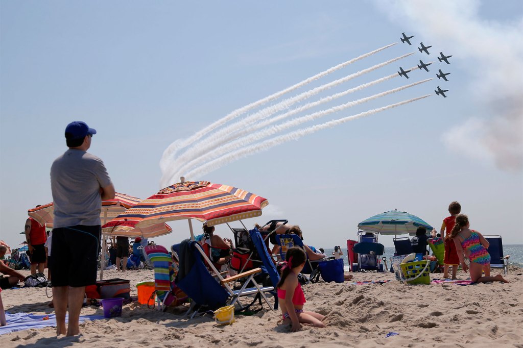 Spectators watch the Breitling Jet Team perform over Jones Beach during the 13th Annual Bethpage Air Show, Saturday, May 28, 2016, at Jones Beach, in Wantagh, N.Y.