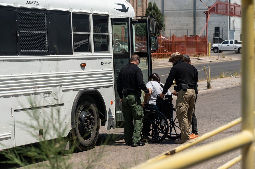 US Customs and Border Protection agents help a migrant as they are dropped off at Annunciation House in El Paso, Texas. 