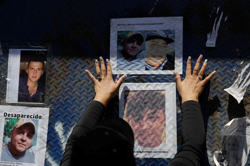 Relatives of missing persons place photographs of their loved ones as they demand the building of a memorial dedicated to all the people that have gone missing in the country, in Mexico City, Mexico May 15, 2022.