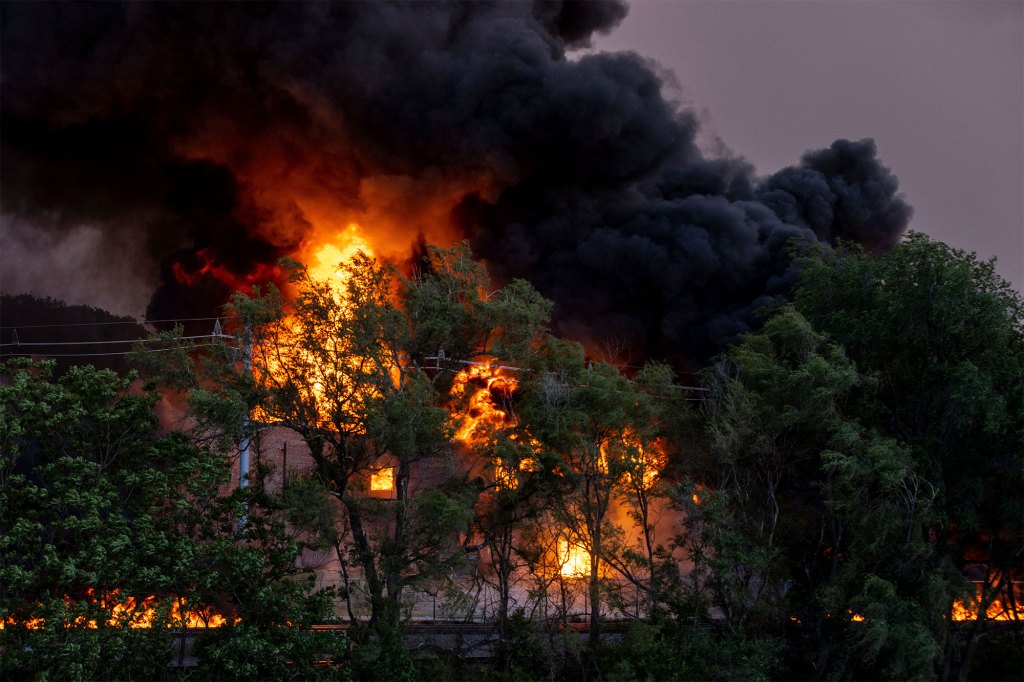 Flames shoot up at the scene of a three-alarm fire at Nox-Crete, Inc., in Omaha, Neb.