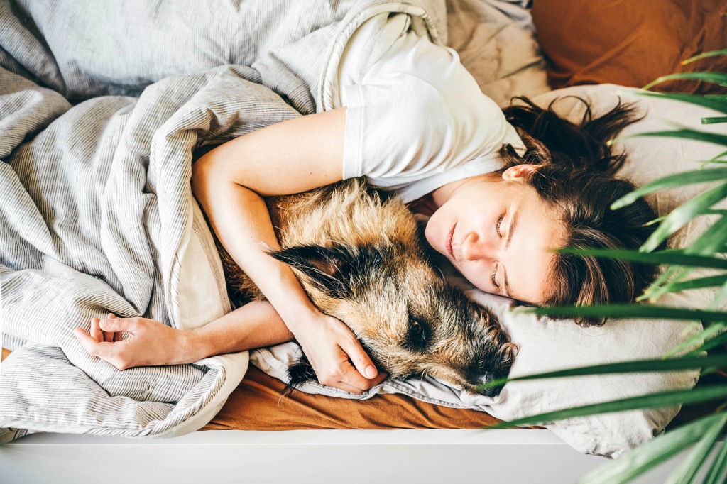 Woman in bed with dog