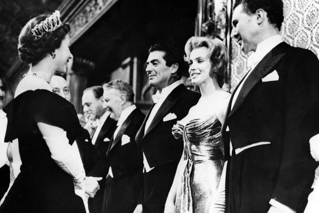 Marilyn Monroe is presented to Queen Elizabeth II at the royal charity performance of "The Battle of the River Plate" at the Empire Theatre in London.