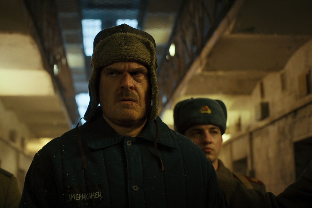 David Harbour scowls in a Russian hat. 