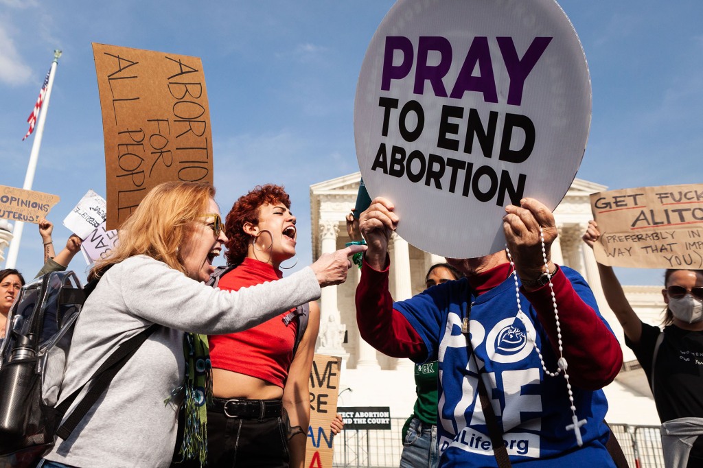 Pro-choice activists object to a pro-life supporter trying to provoke arguments outside the Supreme Court.